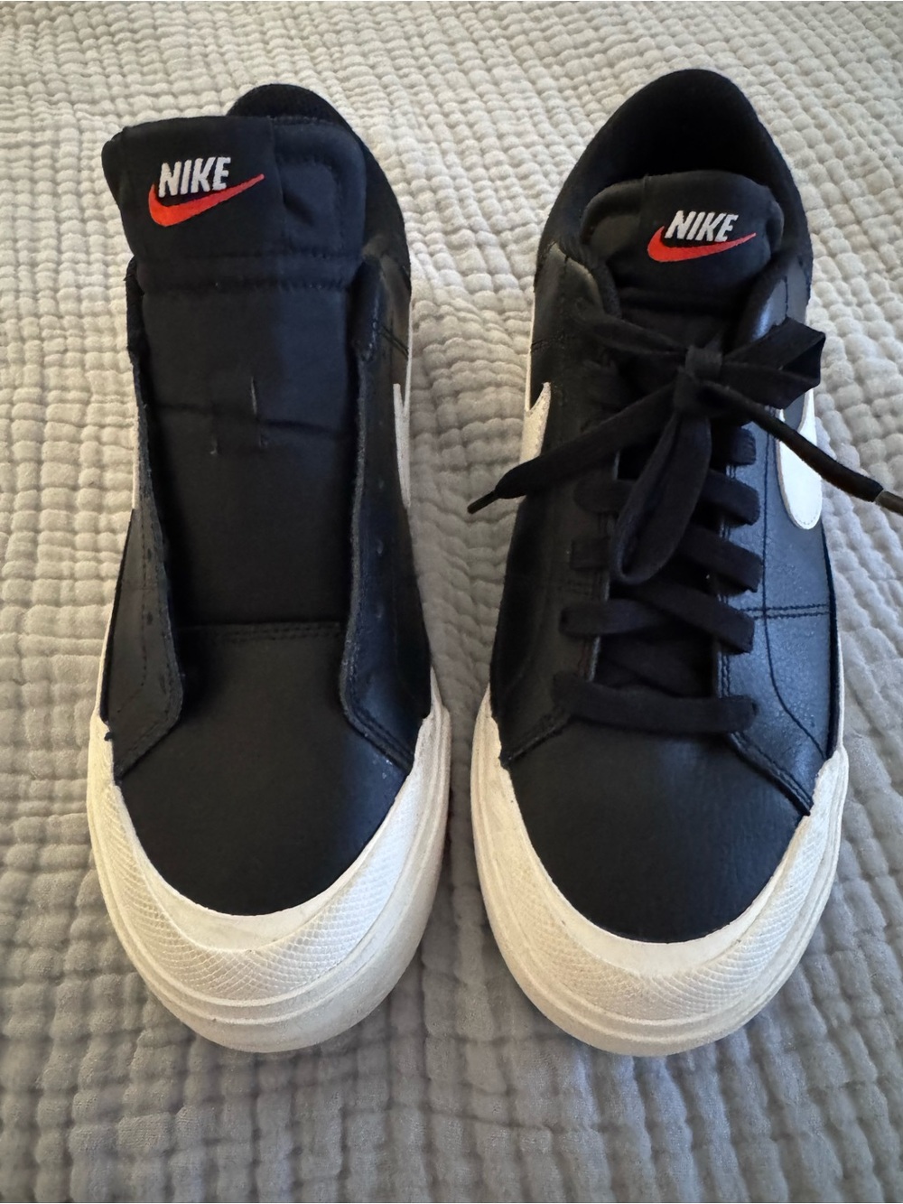 Nike Black and White Sneakers with Red Swoosh missing one shoelace